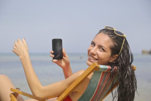 Girl on beach with phone