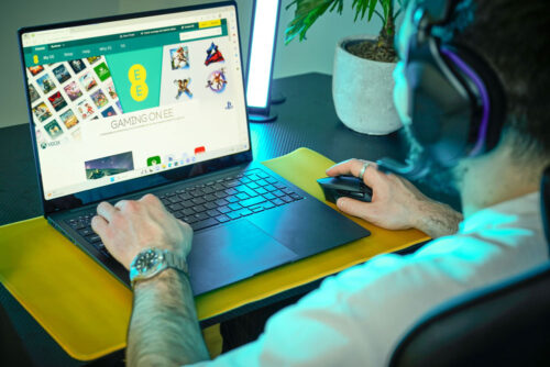 Gamer playing on an EE gaming laptop
