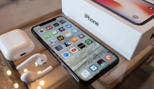 Apple iPhone and iPhone box and Airpods on a table