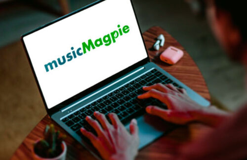 MusicMagpie logo showing on a laptop on a person's lap